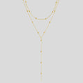 Collier long multi-rangs femme – pendentif géométrique, perles & franges, style minimaliste élégant